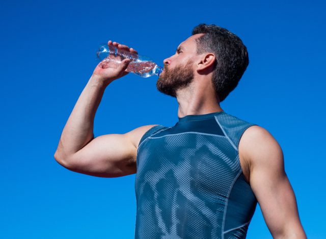 sportsman drinking water outside on a sunny summer day